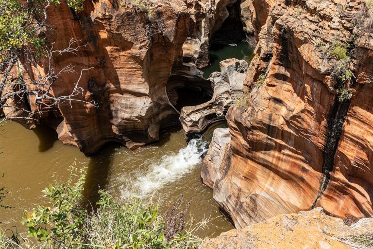 River water flowing between sculpted sandstone walls