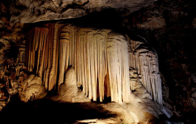 Illuminated limestone formations inside the Cango Caves