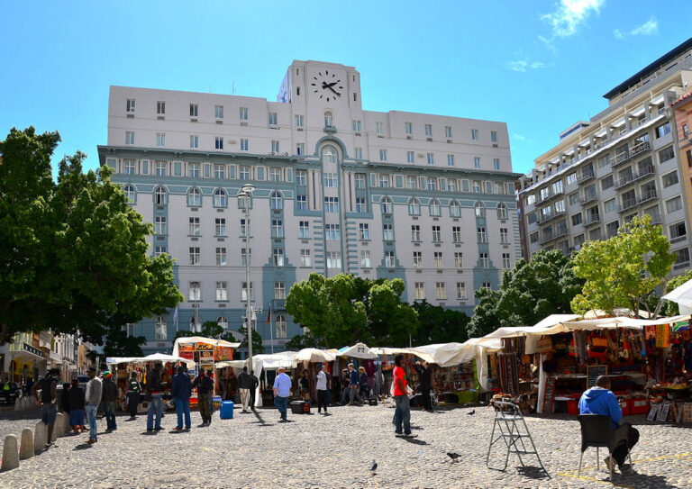 Market stalls in a Cape Town square beneath a clock-fronted building