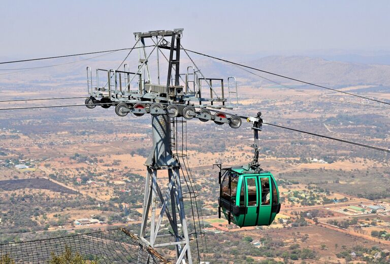 Green cable car high above the surrounding countryside