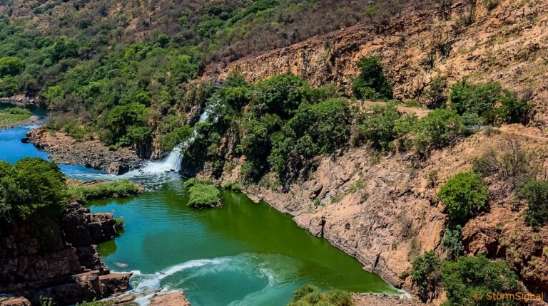 River gorge with a waterfall and green vegetation