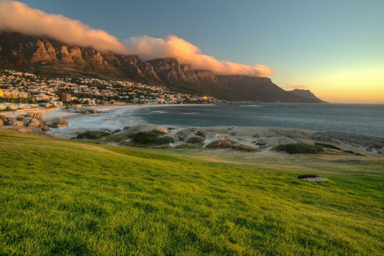 Grassy shoreline and rocky coves beneath Cape Town’s coastal mountains