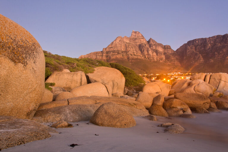Granite boulders and coastal mountains in warm evening light
