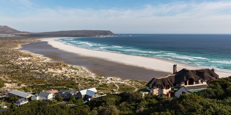 Long curve of Noordhoek Beach beneath the surrounding hills