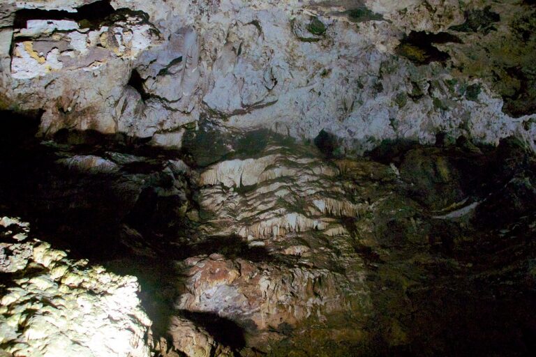 Rocky limestone ceiling inside a cave chamber