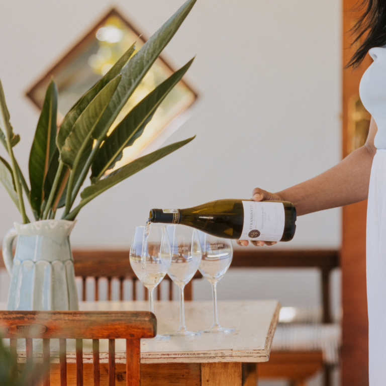 Wine being poured at a tasting table