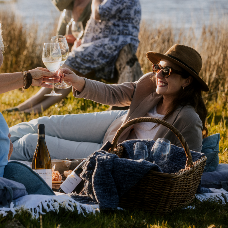 Visitor relaxing with a glass of wine in an outdoor chair