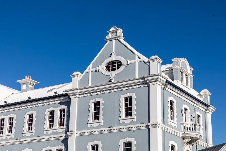 Gabled white waterfront building beneath a blue sky